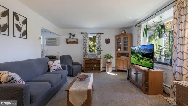 a dining room with furniture and a floor to ceiling window
