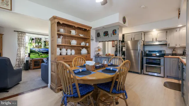 a kitchen with stainless steel appliances granite countertop a refrigerator stove and sink