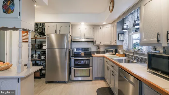 a kitchen with a stove and a refrigerator