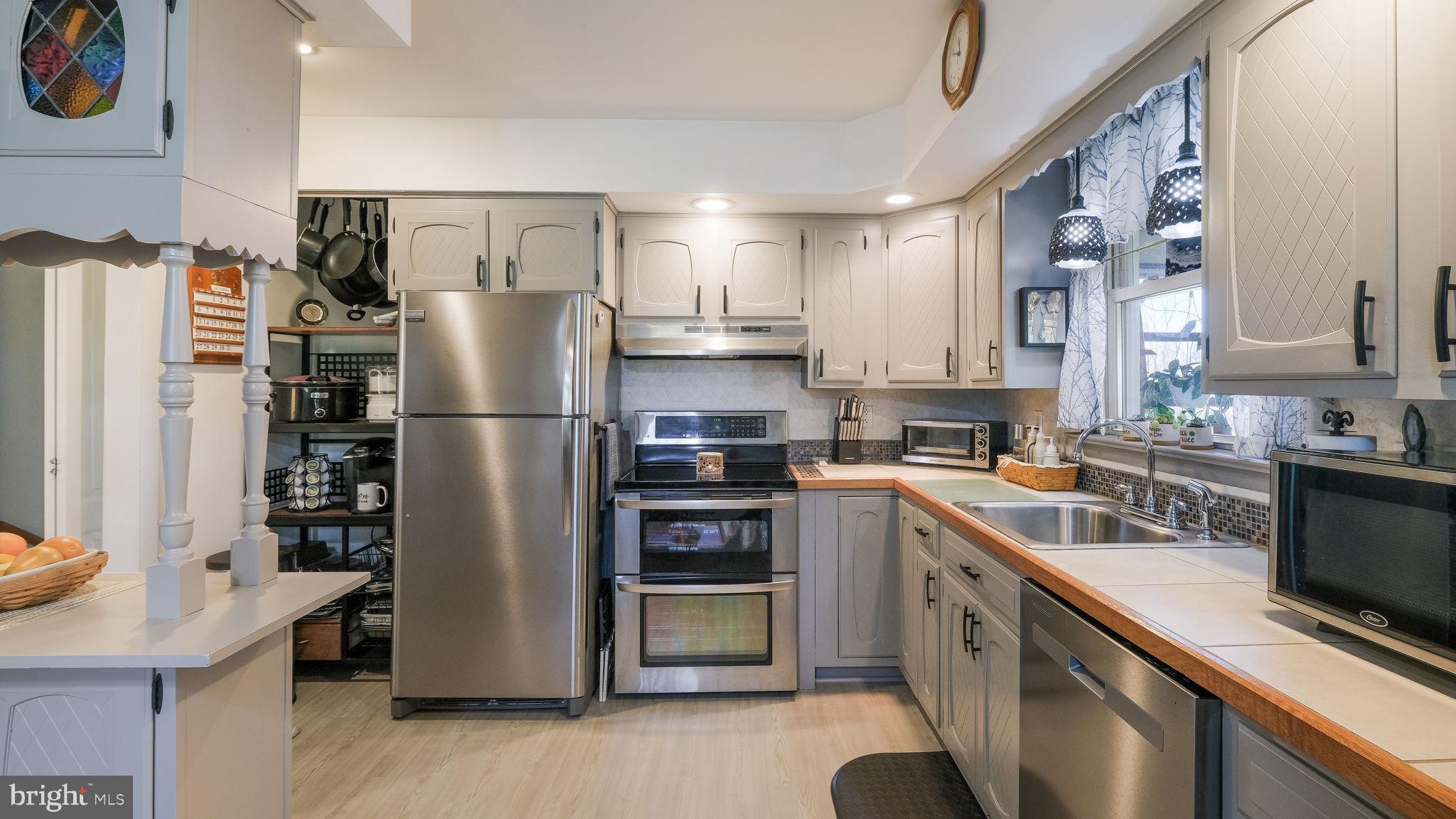 7078 Easton Road Pipersville, PA 18947 - Photo 10 of 45 a kitchen with stainless steel appliances granite countertop a refrigerator stove and sink