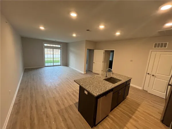 a kitchen with sink cabinets and wooden floor