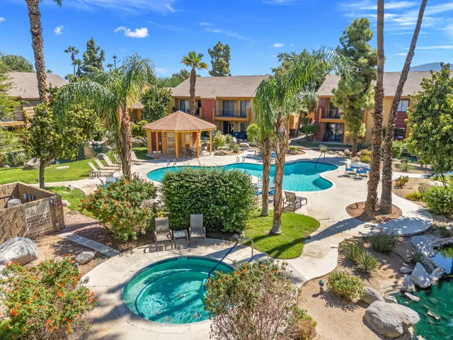 a front view of a house with a yard and potted plants
