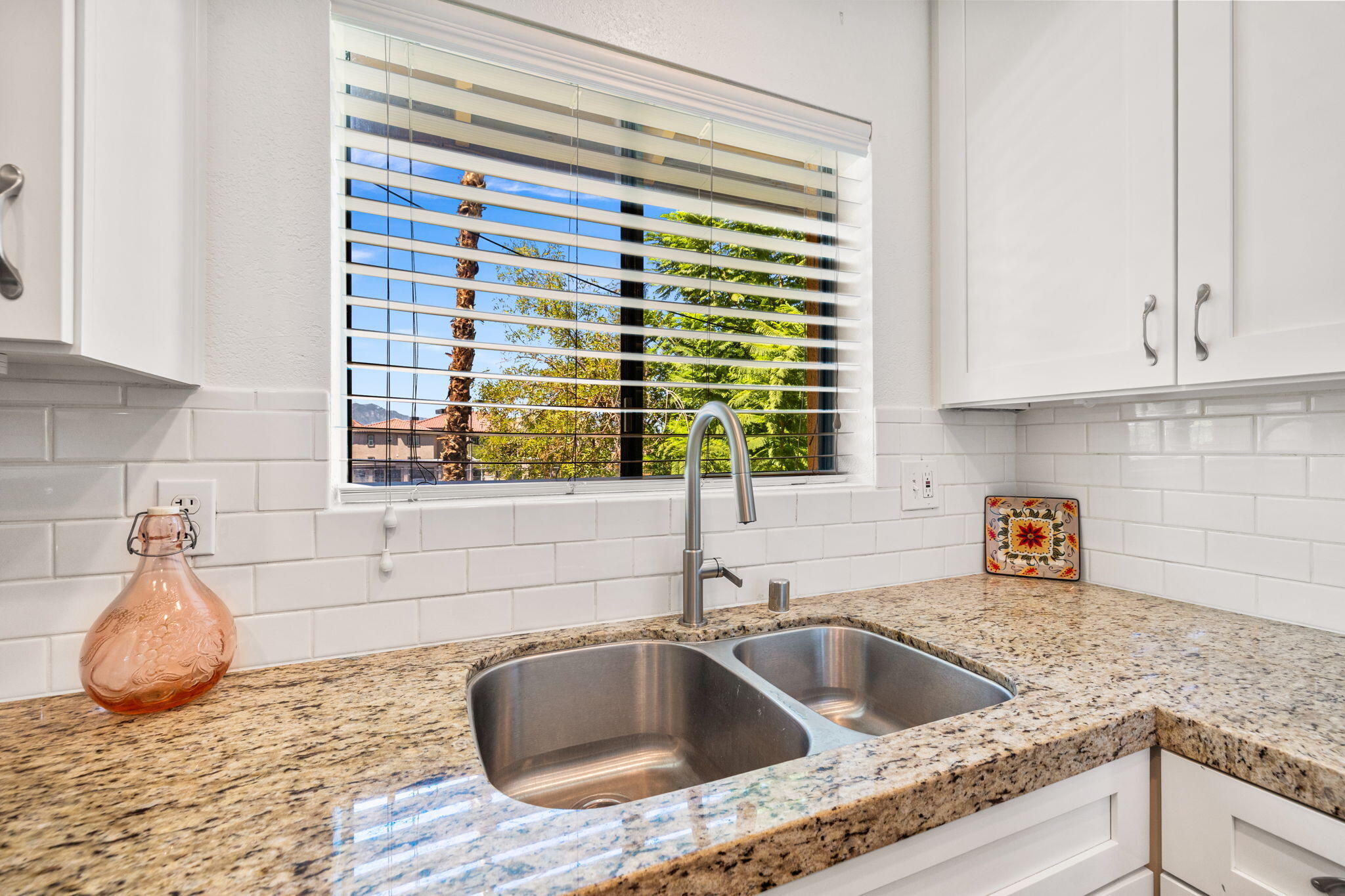 48255 Monroe Street, Unit 59 Indio, CA 92201 - Photo 12 of 58 a kitchen with granite countertop a sink and a window