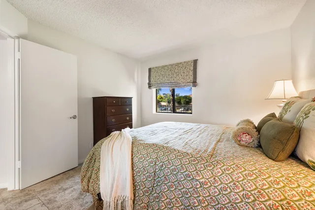 a bedroom with a bed and a mirror