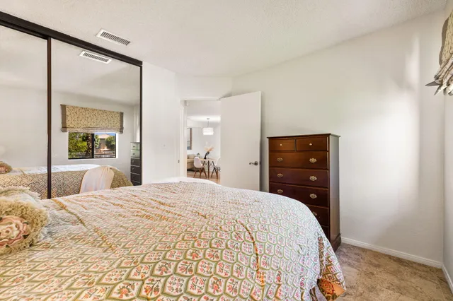 a bathroom with a granite countertop sink a toilet and a bathtub