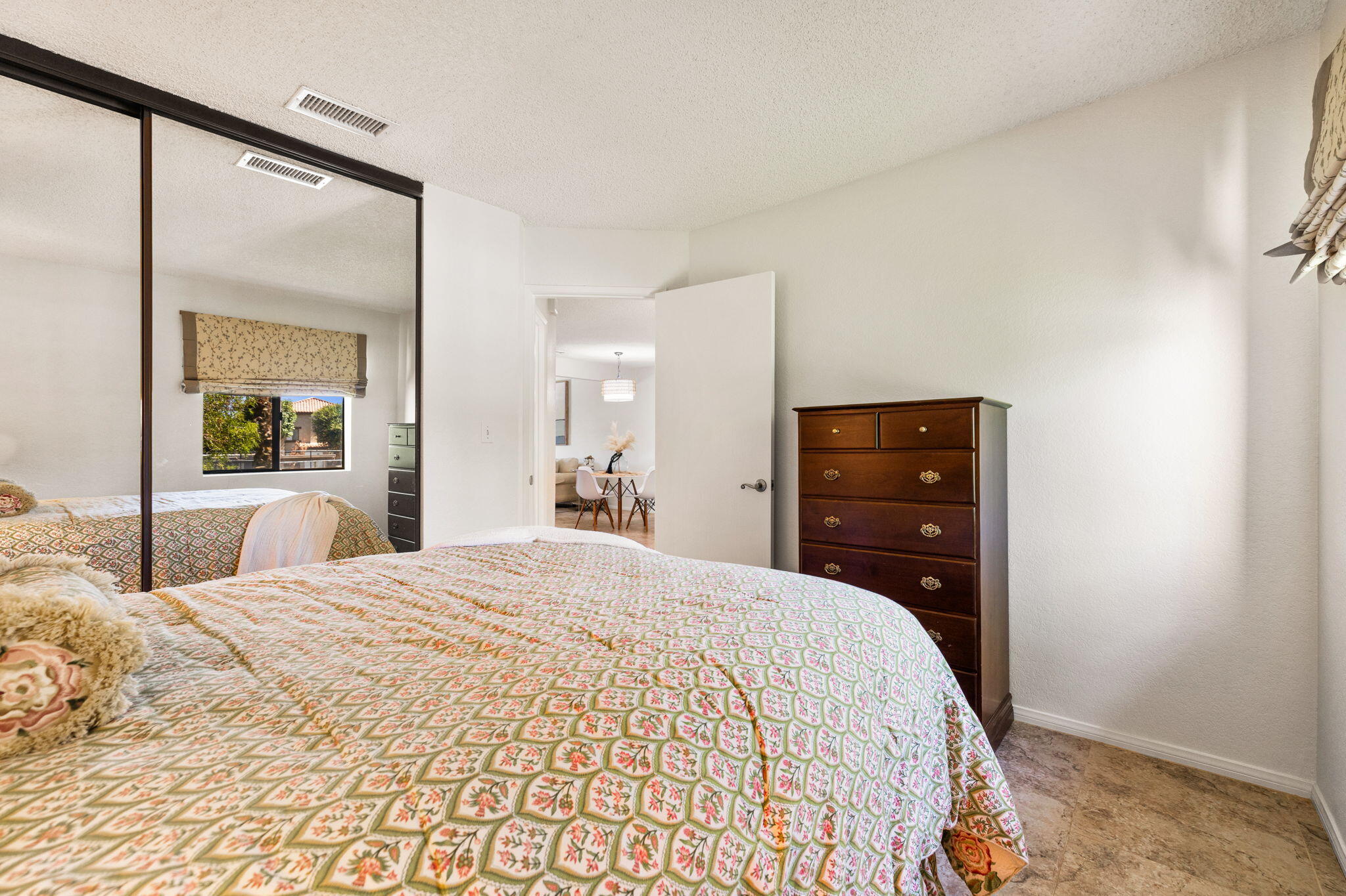 48255 Monroe Street, Unit 59 Indio, CA 92201 - Photo 15 of 58 a bedroom with a bed and a mirror