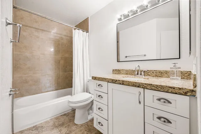 a bathroom with a toilet and bathtub