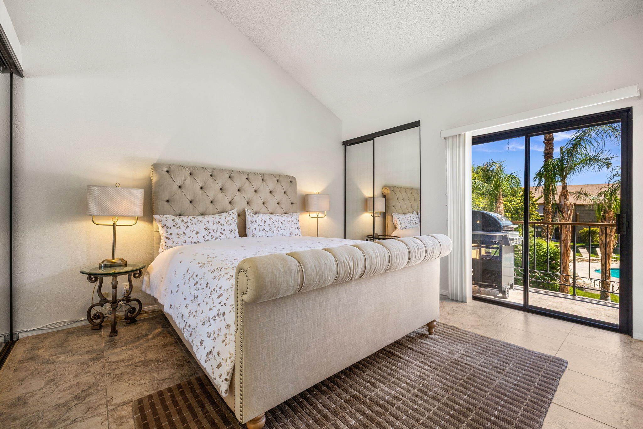 48255 Monroe Street, Unit 59 Indio, CA 92201 - Photo 18 of 58 a bedroom with a large bed and a large window