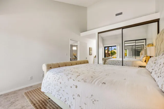 a bathroom with a granite countertop sink toilet mirror and bathtub