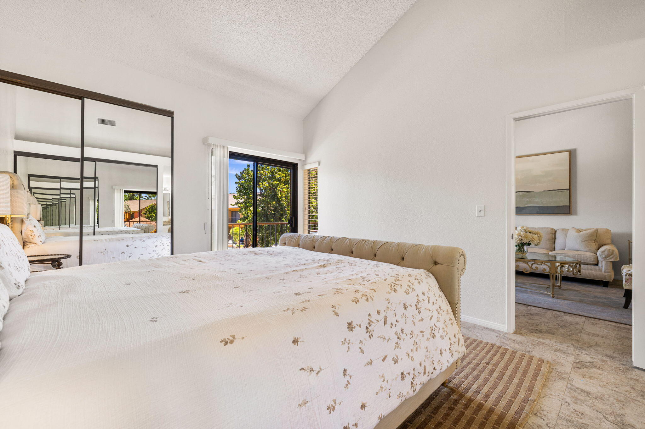 48255 Monroe Street, Unit 59 Indio, CA 92201 - Photo 20 of 58 a bedroom with a bed and a large mirror