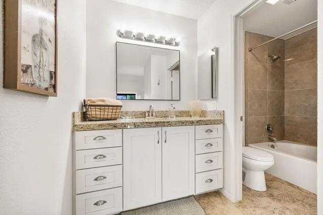 a view of a balcony with wooden floor and outdoor seating