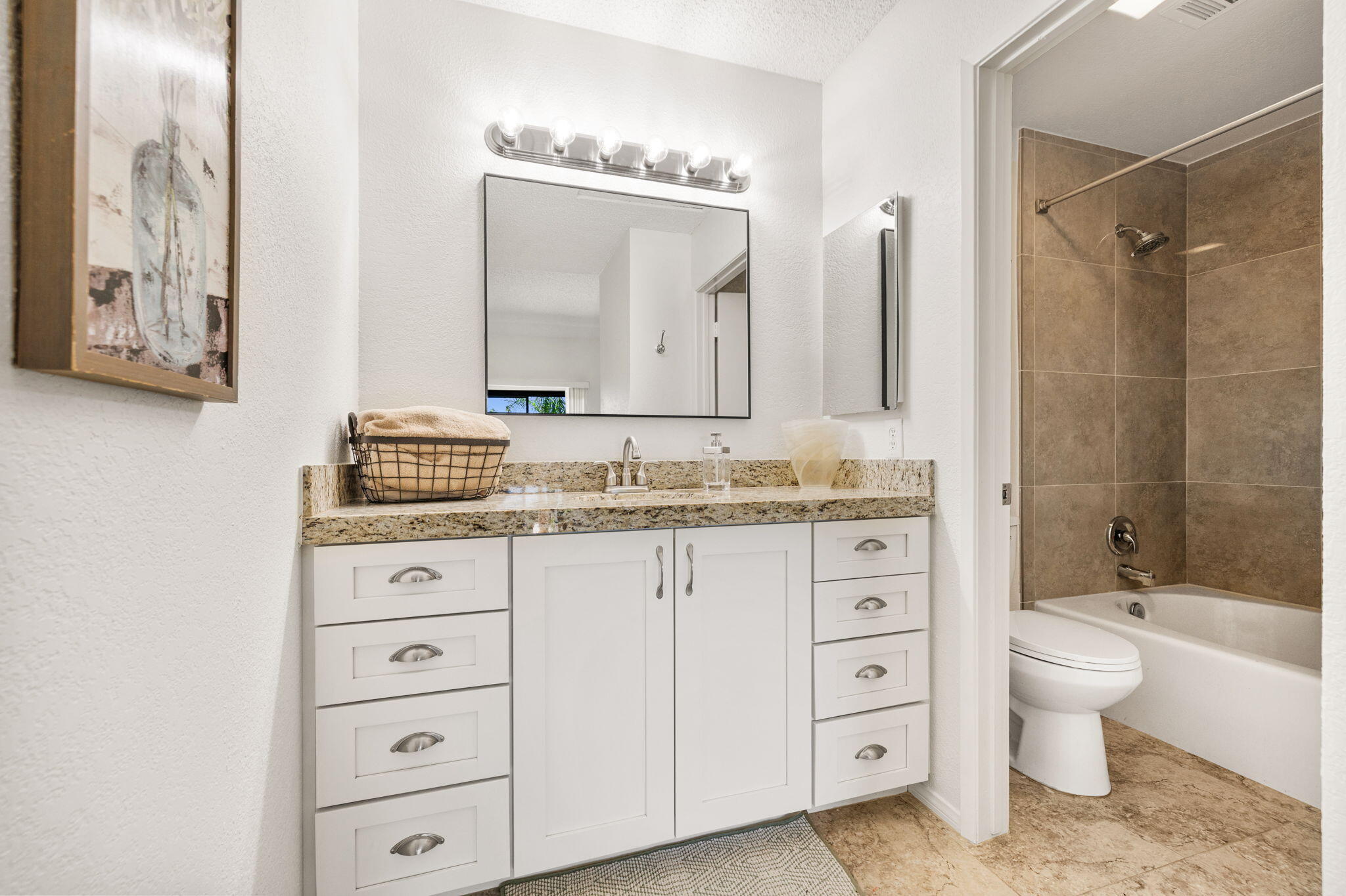 48255 Monroe Street, Unit 59 Indio, CA 92201 - Photo 21 of 58 a bathroom with a granite countertop sink toilet mirror and bathtub
