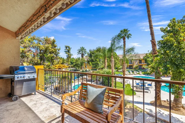a balcony with chairs and a table