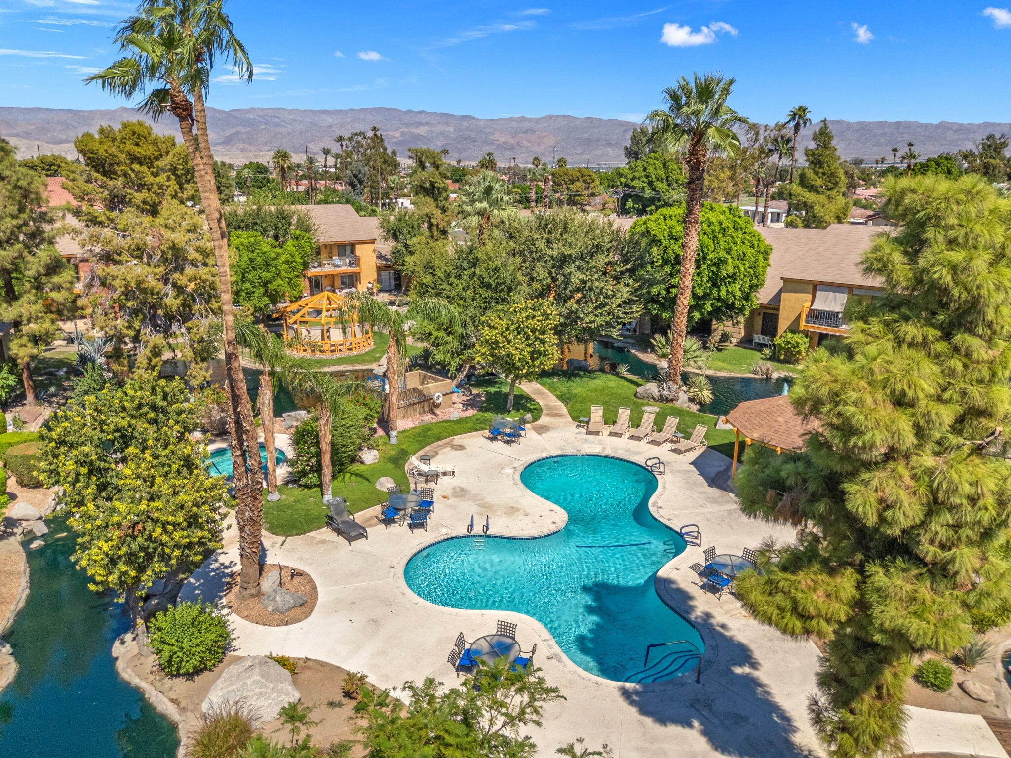 48255 Monroe Street, Unit 59 Indio, CA 92201 - Photo 29 of 58 a view of a swimming pool of a house with a yard