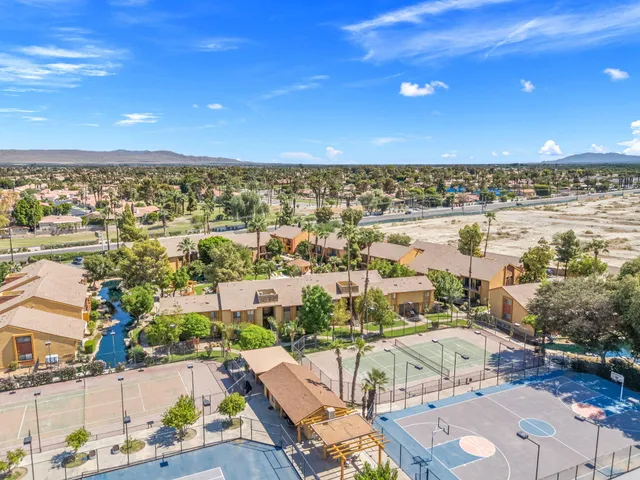 a swimming pool with outdoor seating and yard