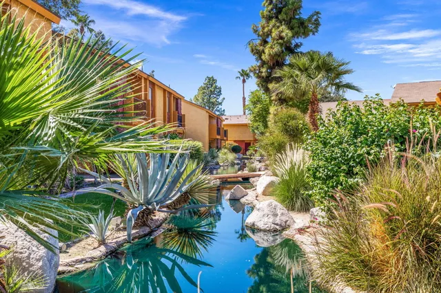 a front view of a house with swimming pool having outdoor seating