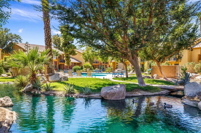 a swimming pool with outdoor seating and yard