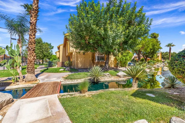 a view of backyard with garden and trees