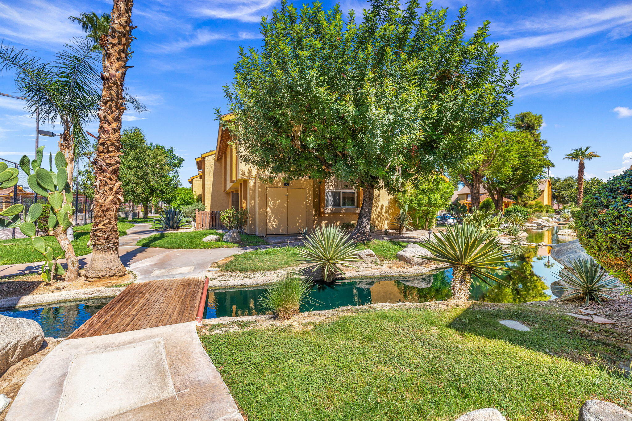 48255 Monroe Street, Unit 59 Indio, CA 92201 - Photo 48 of 58 a view of yard with swimming pool and outdoor seating