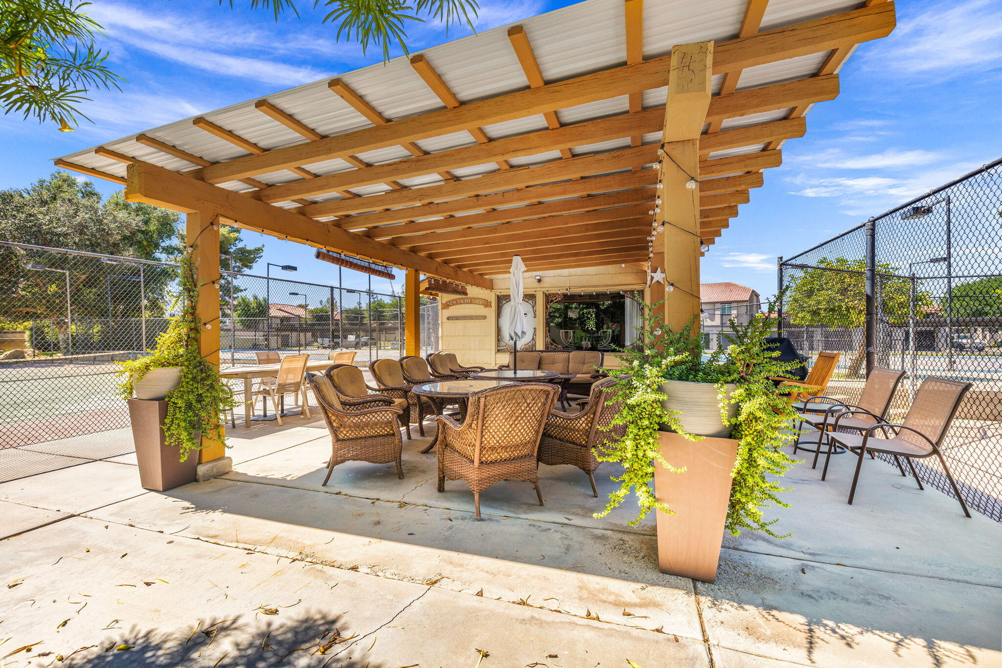 48255 Monroe Street, Unit 59 Indio, CA 92201 - Photo 53 of 58 a view of a patio with a dining table and chairs with wooden floor