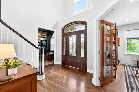a view of an entryway with wooden floor and a livingroom