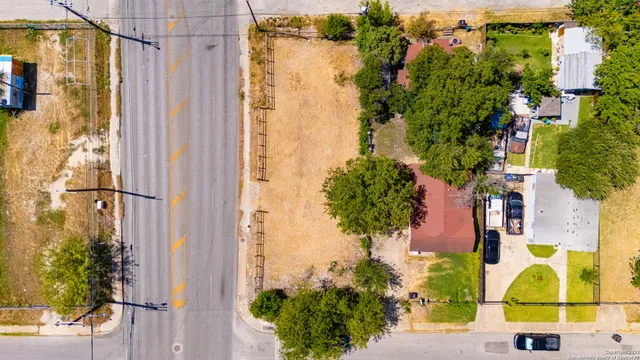 an aerial view of a house with a backyard