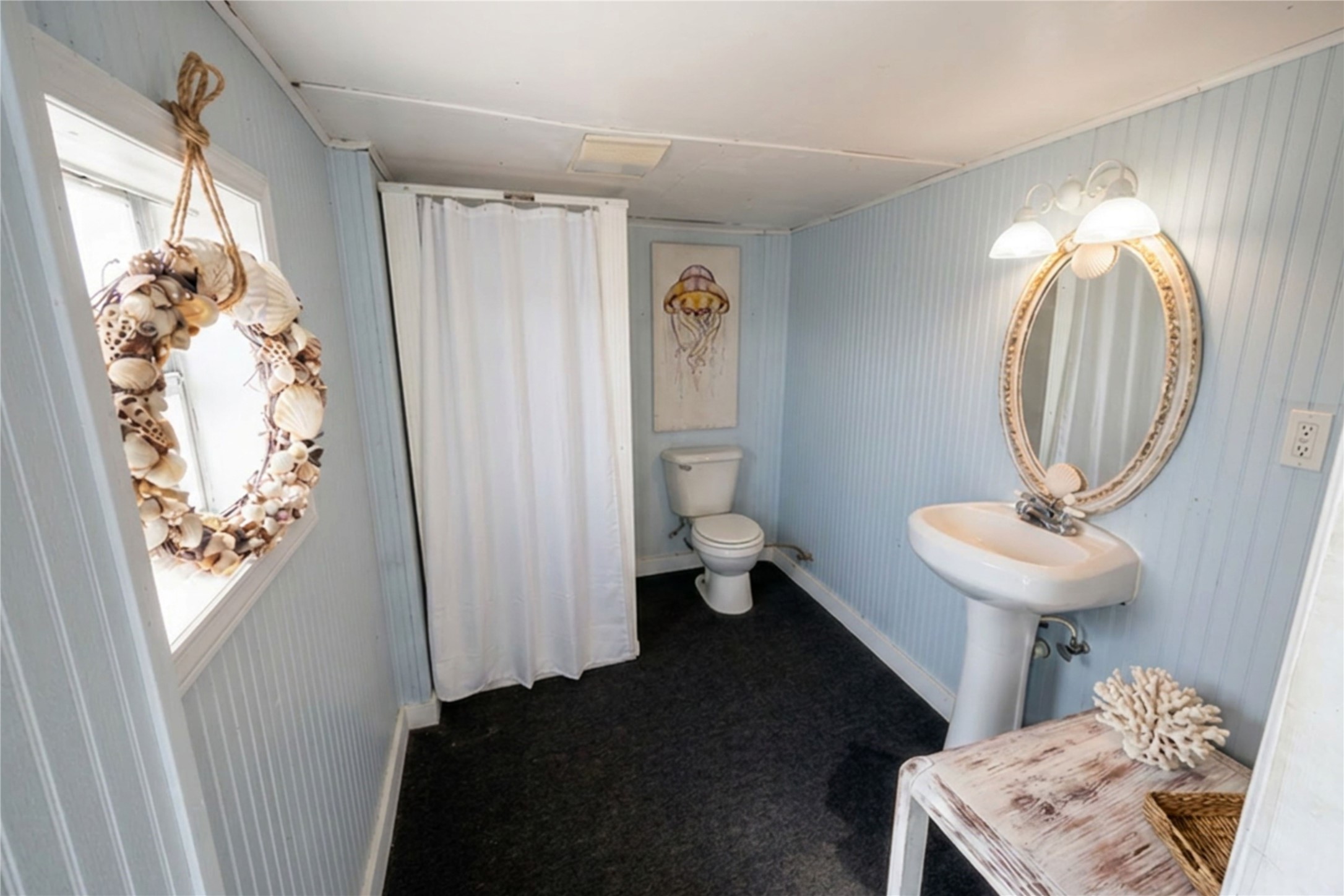 959 South East Road Crystal Beach, TX 77650 - Photo 20 of 20 a bathroom with a sink a toilet and shower curtain