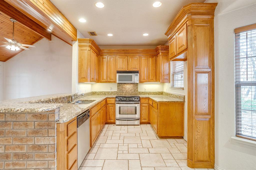 2780 Pear Orchard Road Granbury, TX 76048 - Photo 14 of 40 a kitchen with stainless steel appliances granite countertop a stove a sink and a refrigerator