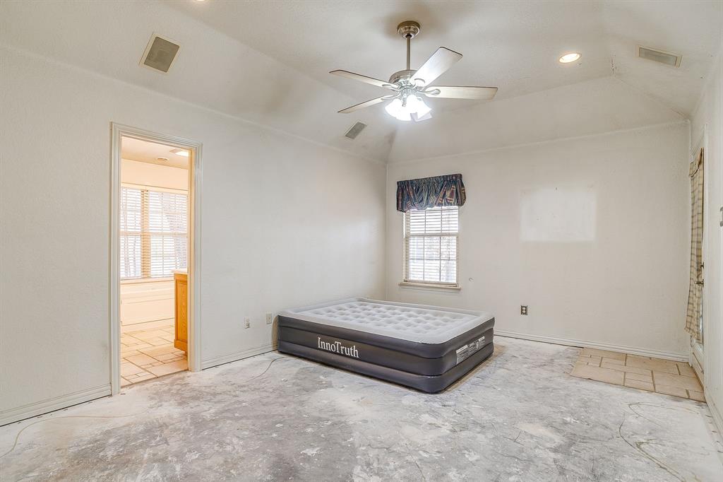 2780 Pear Orchard Road Granbury, TX 76048 - Photo 17 of 40 a spacious bedroom with a bed and a window