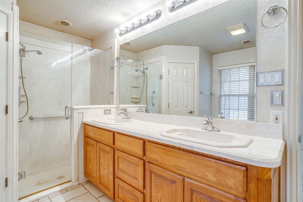 2780 Pear Orchard Road Granbury, TX 76048 - Photo 18 of 40 a bathroom with a double vanity sink mirror and shower