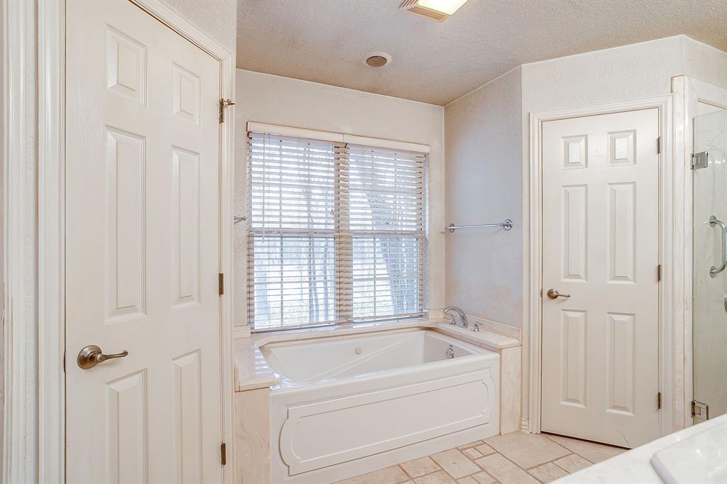 2780 Pear Orchard Road Granbury, TX 76048 - Photo 19 of 40 a bathroom with a bathtub and shower