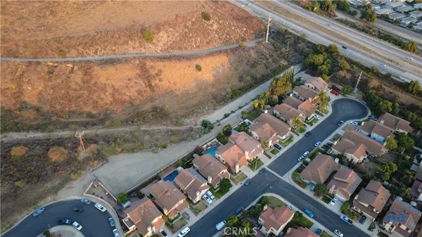 an aerial view of a house with a lake