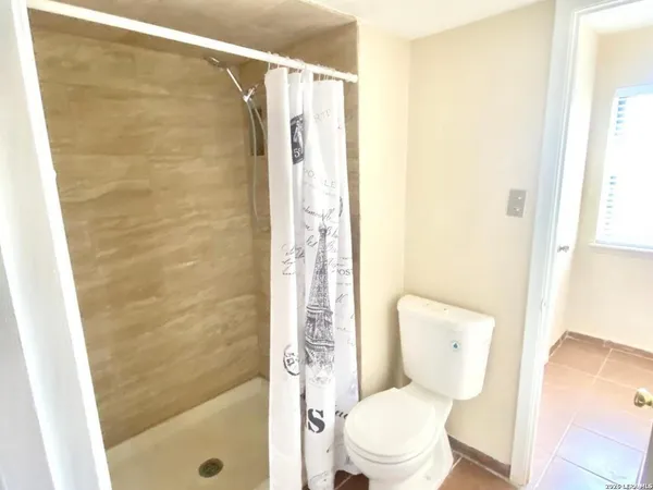 a bathroom with a shower and a bathtub