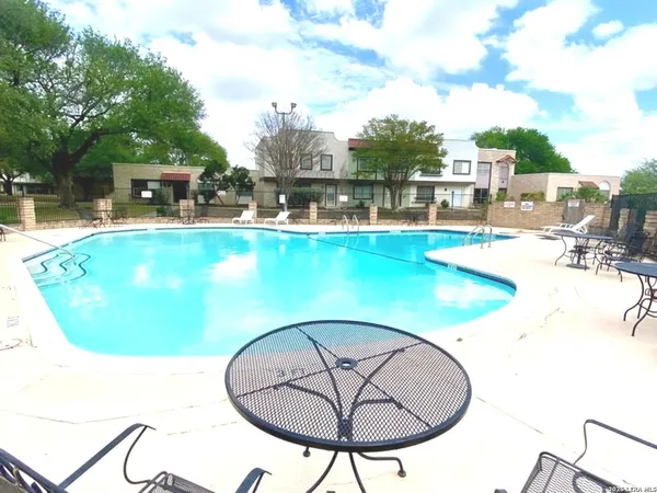 a view of a swimming pool with a lounge chairs