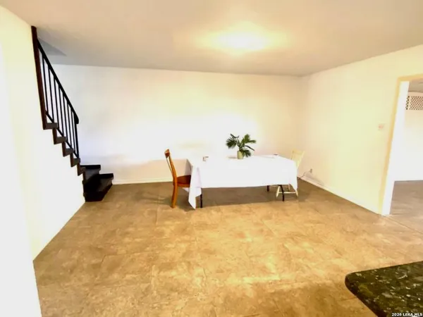 a view of an empty room and stairs