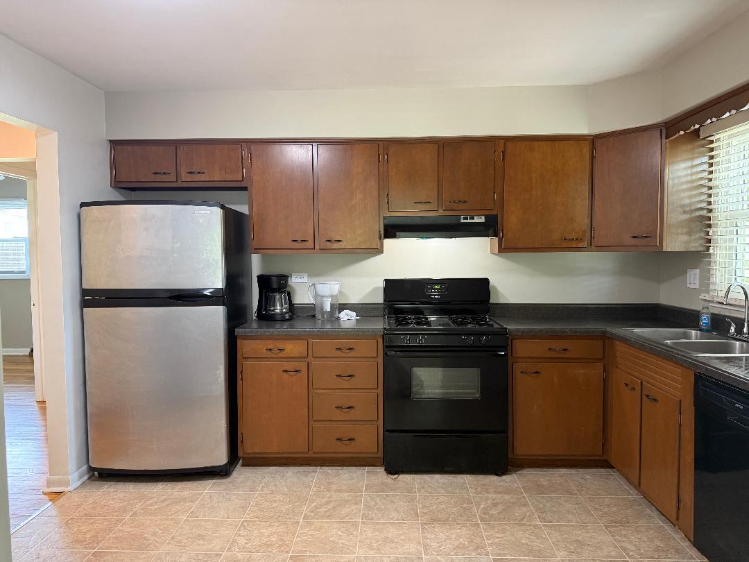 1622 Oak Lane, Unit 2 Sycamore, IL 60178 - Photo 2 of 5 a kitchen with a refrigerator sink and cabinets