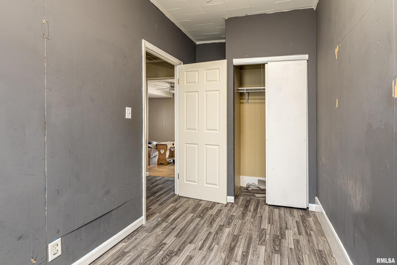1500 West Tyler Street Herrin, IL 62948 - Photo 12 of 17 a view of a hallway with wooden floor and closet