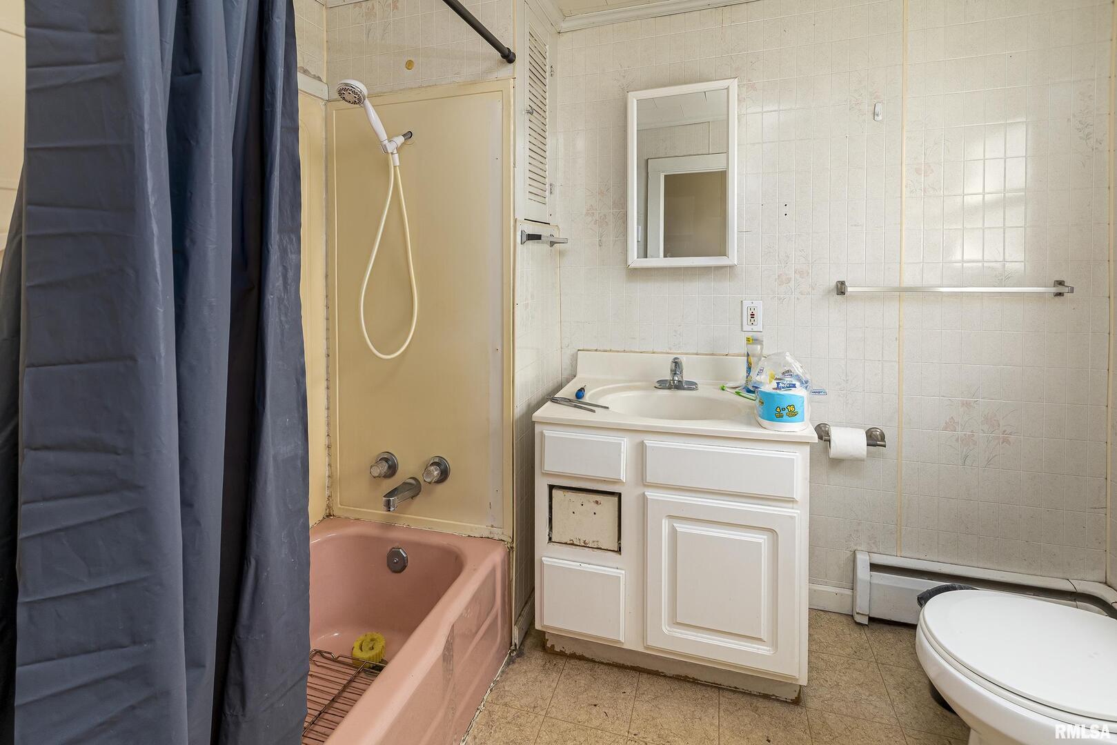 1500 West Tyler Street Herrin, IL 62948 - Photo 13 of 17 a bathroom with a granite countertop sink a toilet and shower