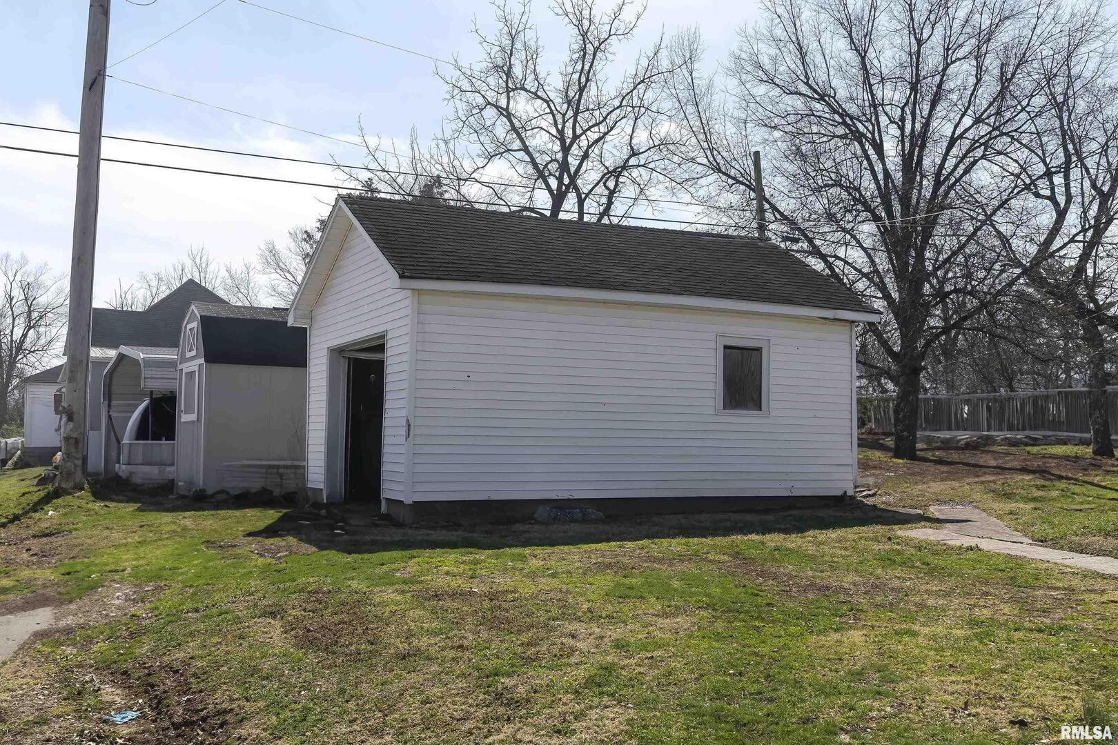 1500 West Tyler Street Herrin, IL 62948 - Photo 17 of 17 a view of a house with backyard and garden