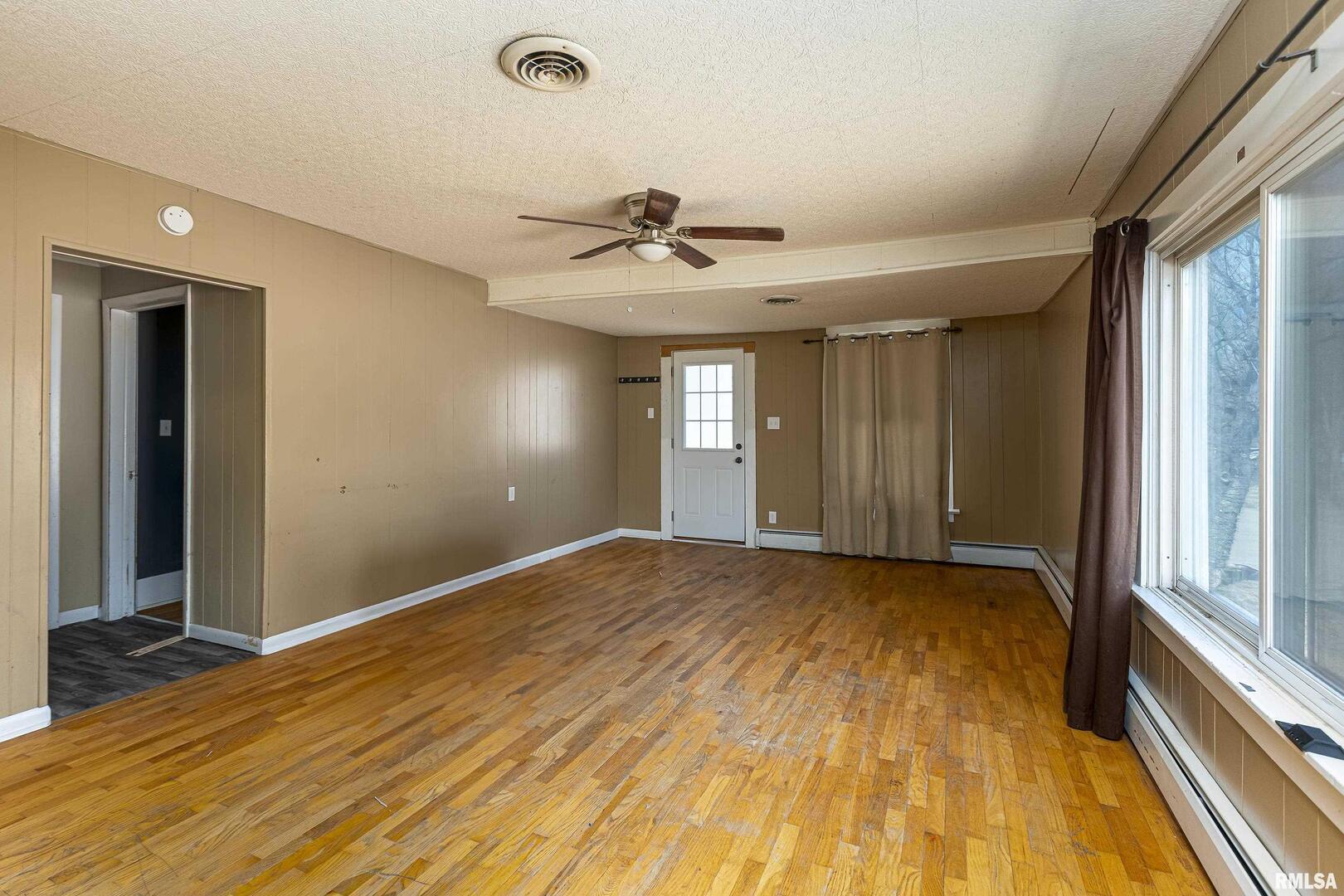 1500 West Tyler Street Herrin, IL 62948 - Photo 4 of 17 a view of an empty room and window and chandelier fan