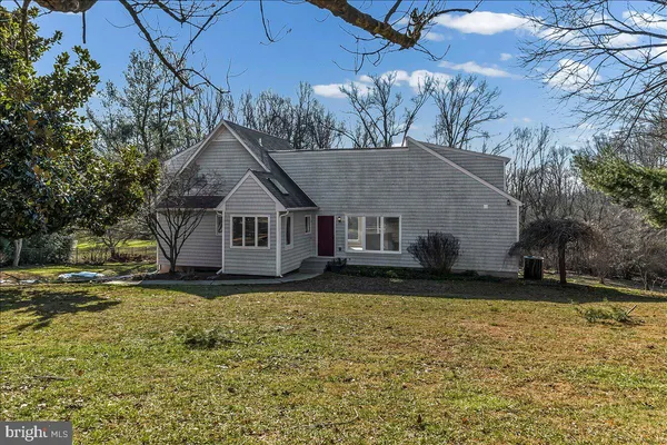 a house that has a big yard with wooden fence