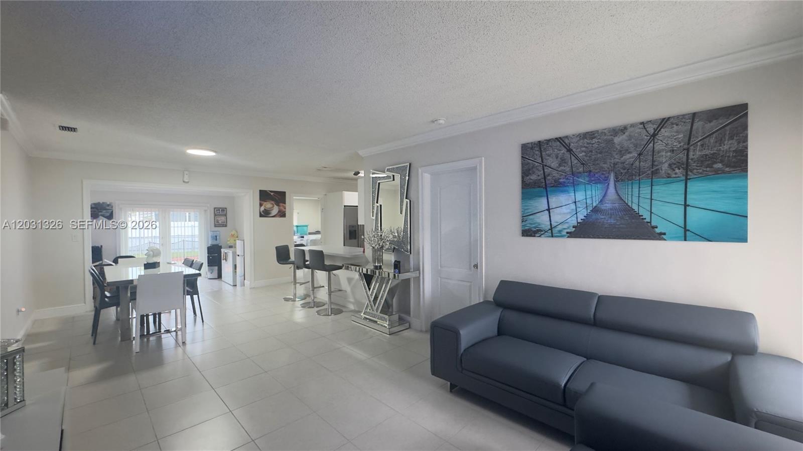 12480 Southwest 189th Street Miami, FL 33177 - Photo 3 of 25 a living room with furniture and a large window