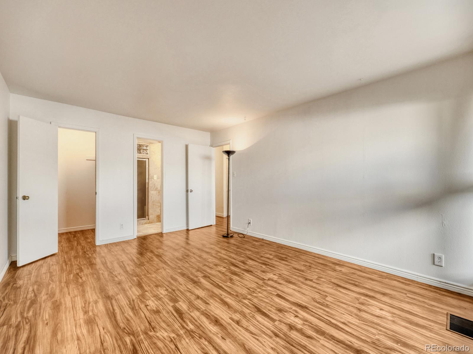 6495 East Happy Canyon Road, Unit 43 Denver, CO 80237 - Photo 12 of 28 a view of an empty room and wooden floor