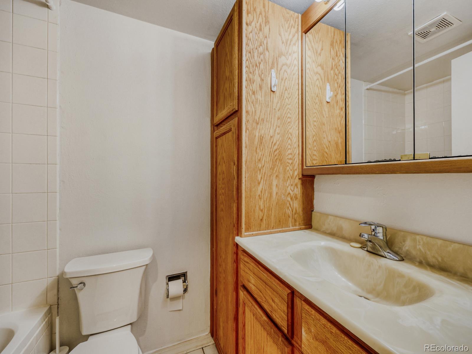 6495 East Happy Canyon Road, Unit 43 Denver, CO 80237 - Photo 16 of 28 a bathroom with a granite countertop sink toilet and shower
