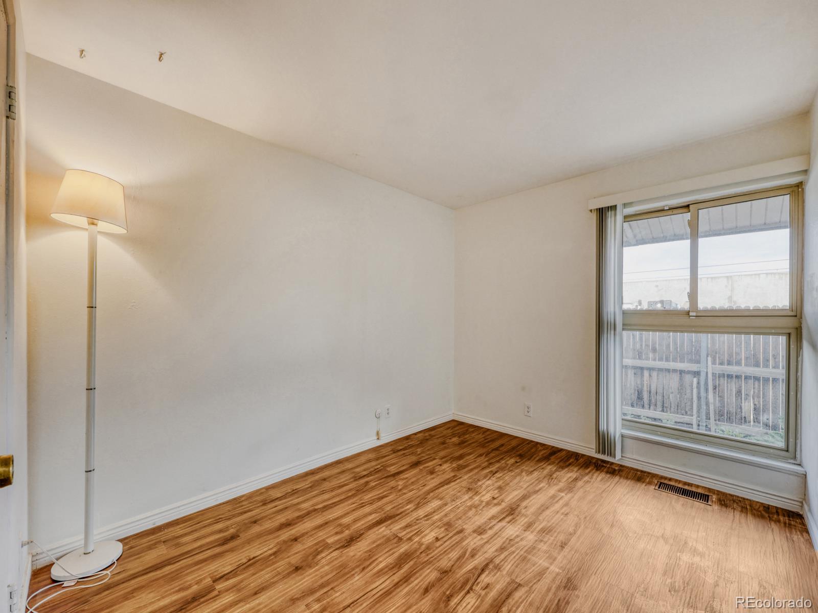 6495 East Happy Canyon Road, Unit 43 Denver, CO 80237 - Photo 20 of 28 a view of empty room with wooden floor and fan