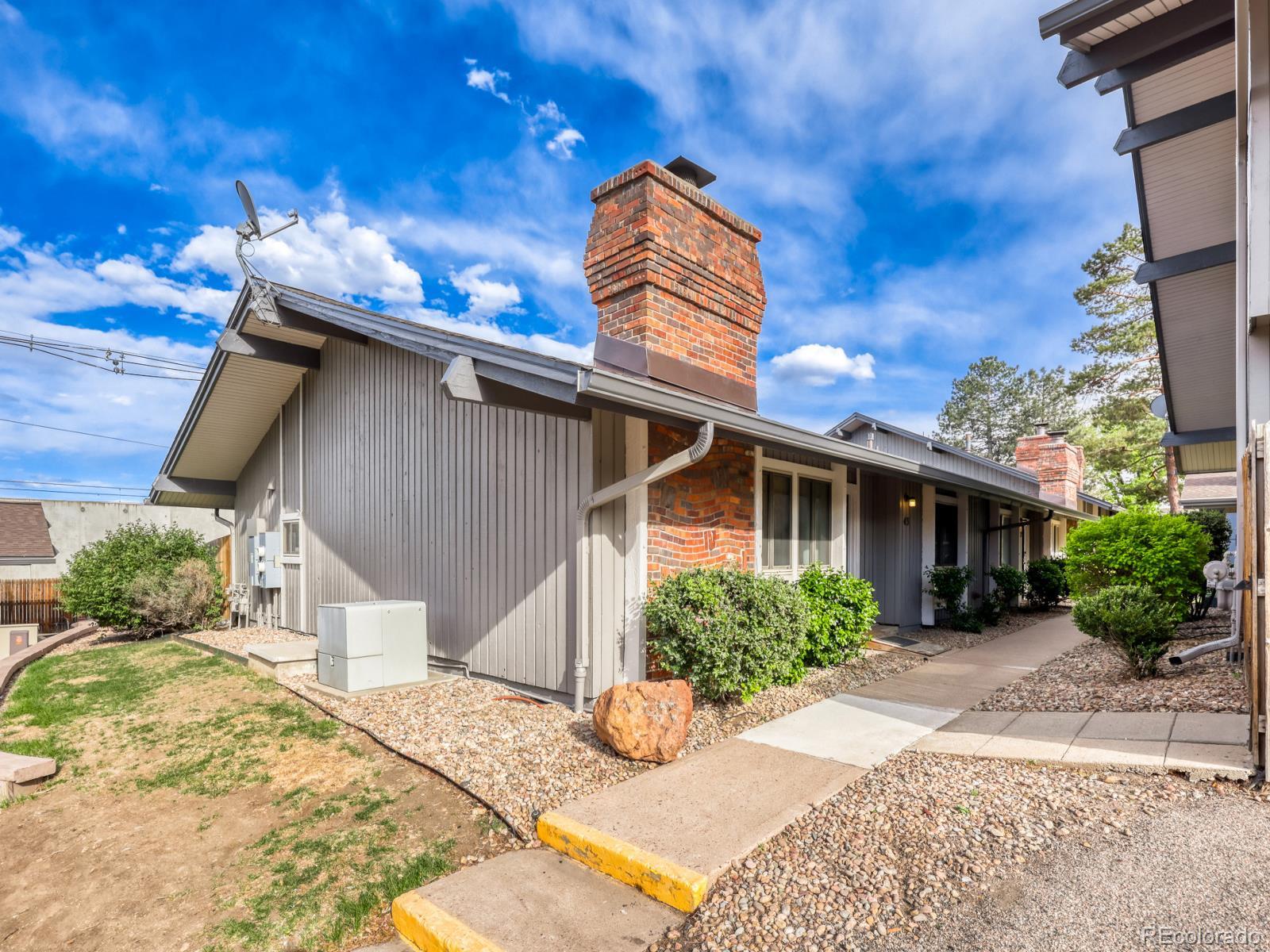 6495 East Happy Canyon Road, Unit 43 Denver, CO 80237 - Photo 2 of 28 a front view of a house with garden