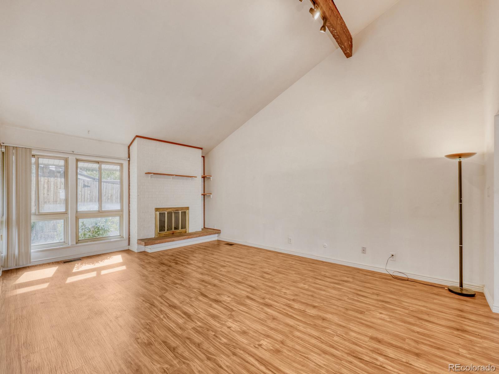 6495 East Happy Canyon Road, Unit 43 Denver, CO 80237 - Photo 3 of 28 a view of an empty room with a window and wooden floor