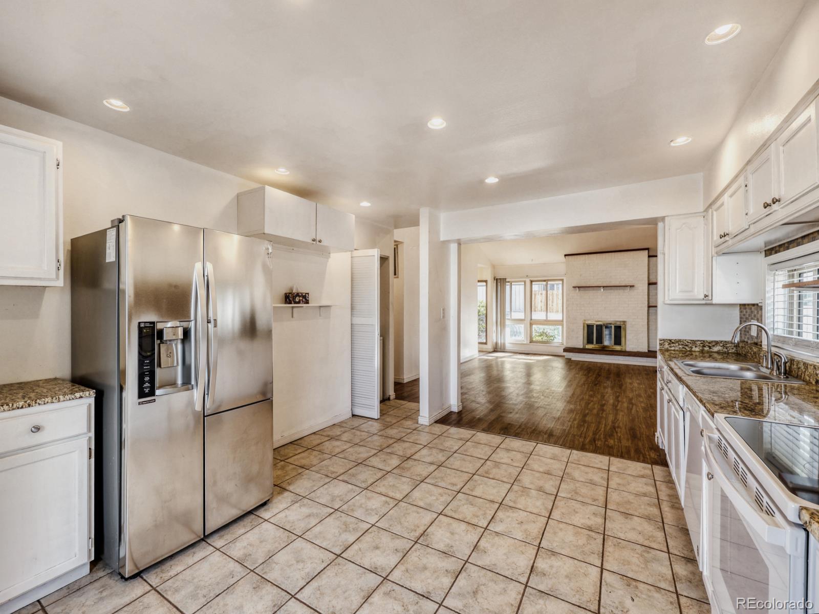 6495 East Happy Canyon Road, Unit 43 Denver, CO 80237 - Photo 5 of 28 a kitchen with stainless steel appliances granite countertop a refrigerator and a stove