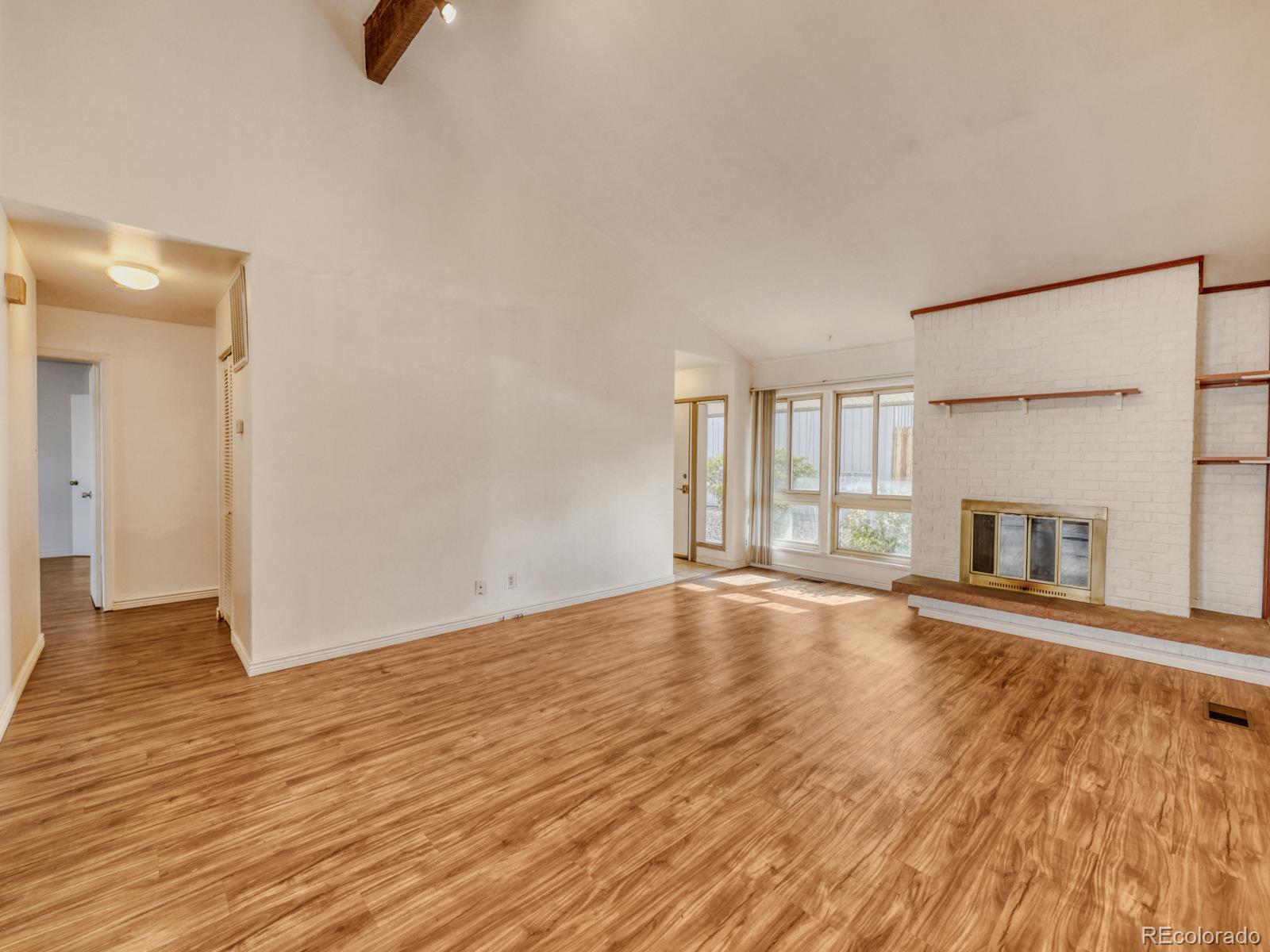 6495 East Happy Canyon Road, Unit 43 Denver, CO 80237 - Photo 6 of 28 a view of an empty room with wooden floor and a window
