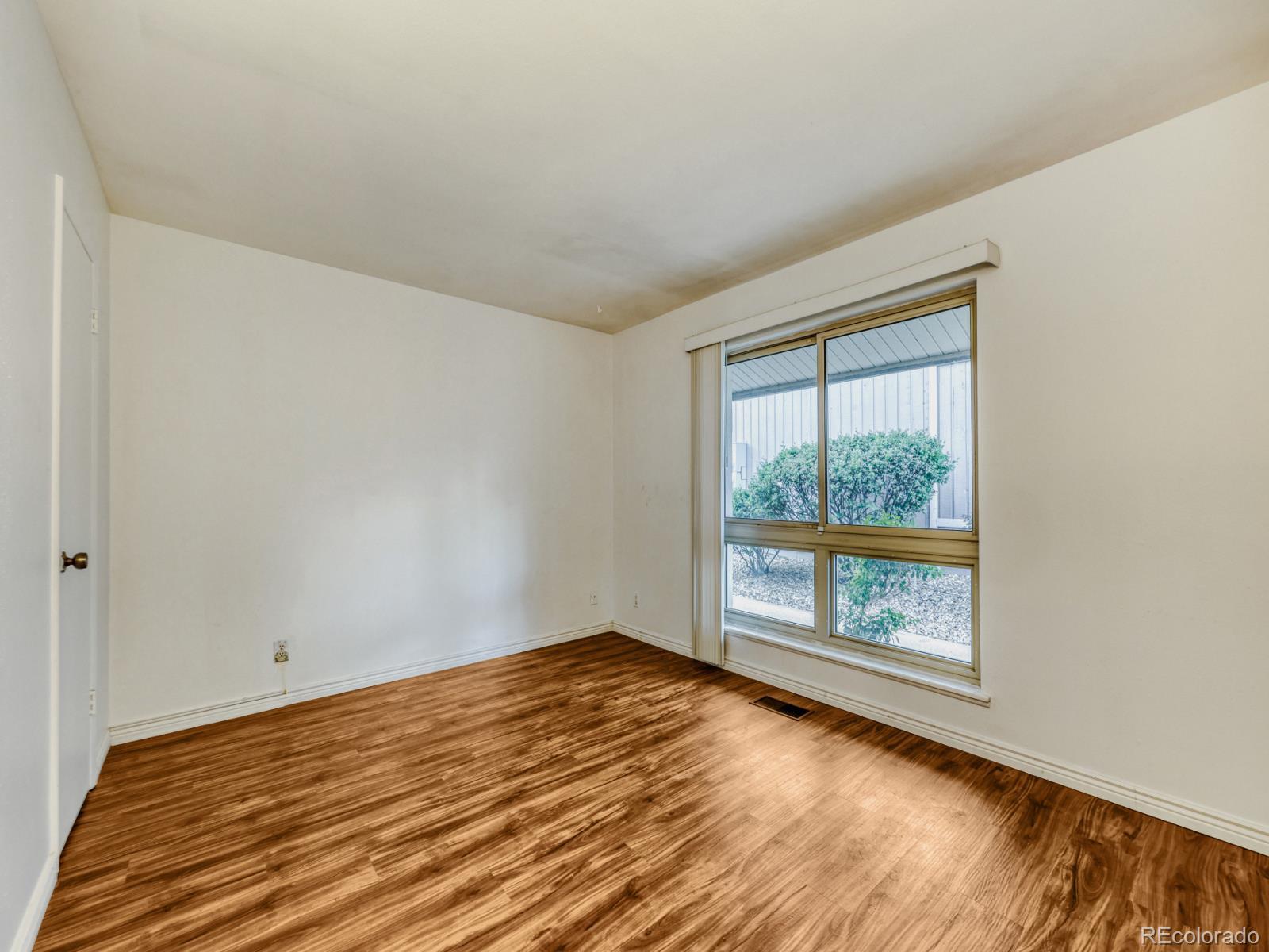 6495 East Happy Canyon Road, Unit 43 Denver, CO 80237 - Photo 10 of 28 a view of empty room with wooden floor and fan